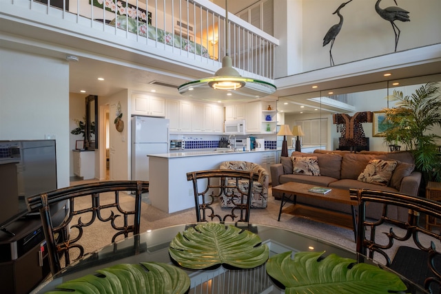 2230 S Kihei Rd Unit 9, Kihei, HI 96753 - living room featuring a high ceiling, light carpet, and recessed lighting