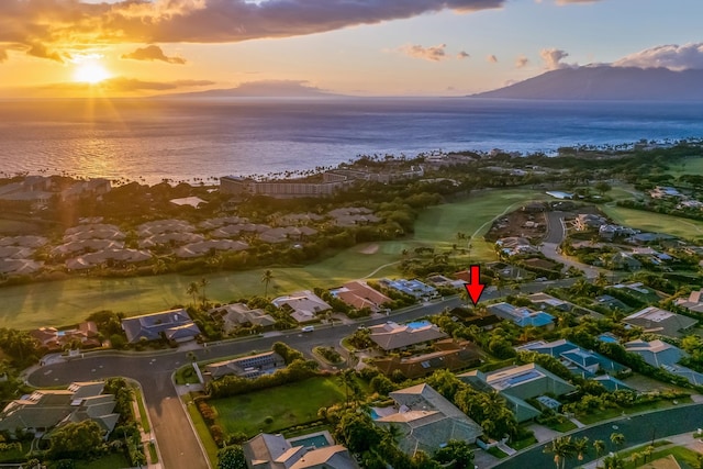 aerial view at dusk featuring a water view