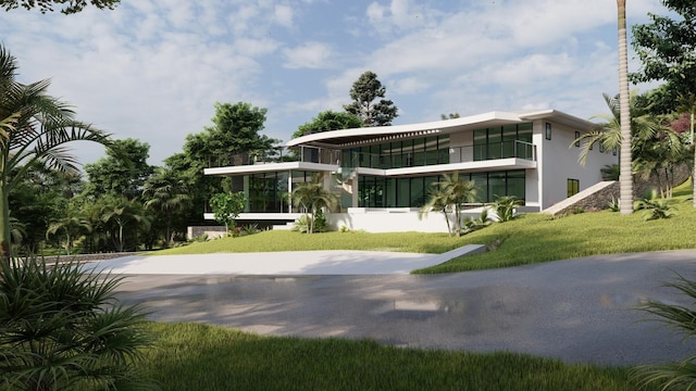 rear view of house featuring a sunroom and a yard