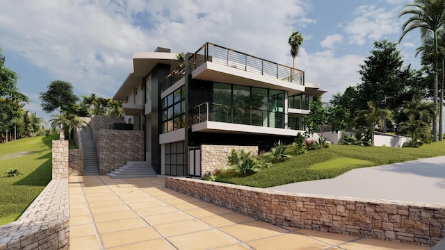 view of front of property featuring a balcony and a front lawn