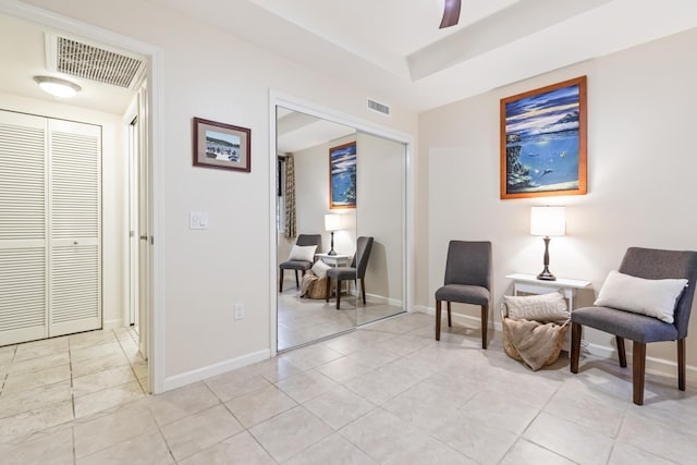 sitting room featuring baseboards, visible vents, and light tile patterned flooring