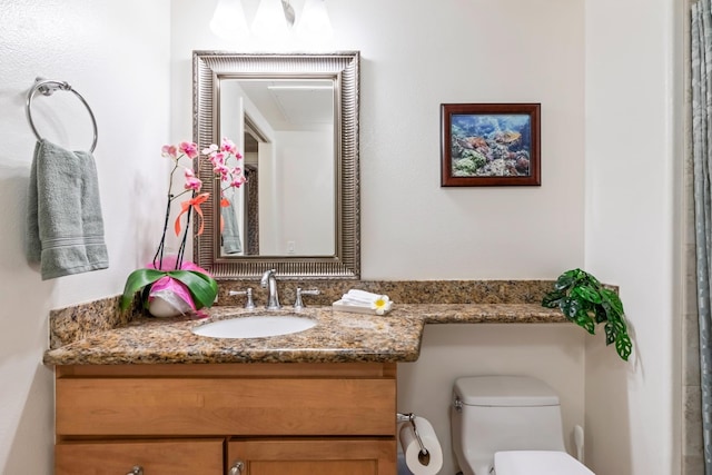 bathroom with toilet and vanity