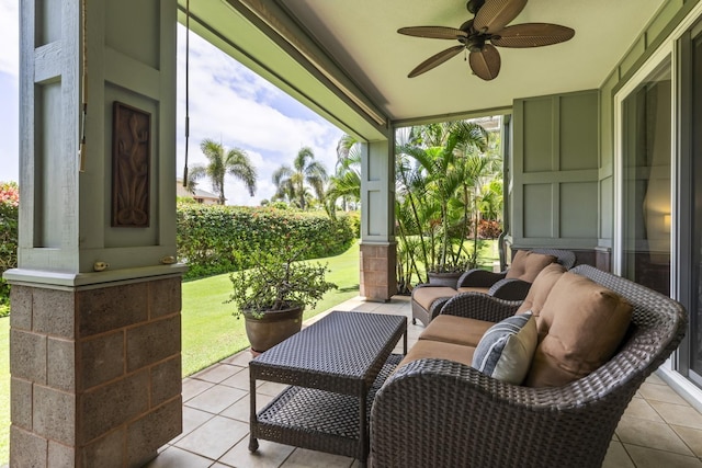 sunroom featuring tile patterned floors, ceiling fan, and vaulted ceiling