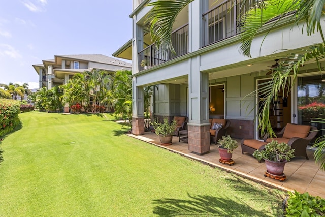 view of yard featuring a patio area and a balcony