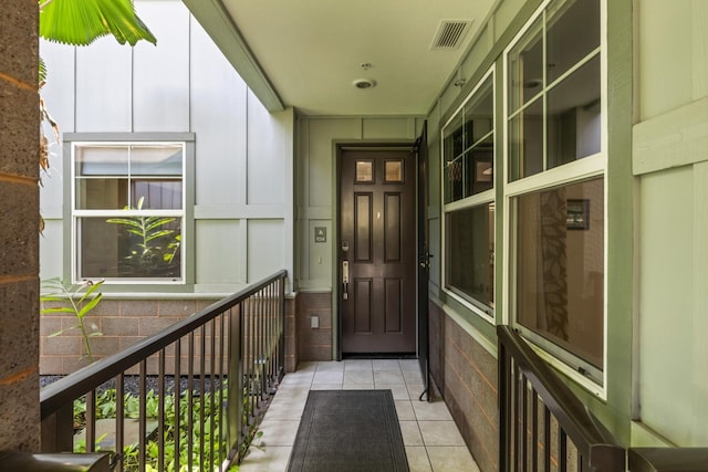 entrance to property featuring visible vents and board and batten siding