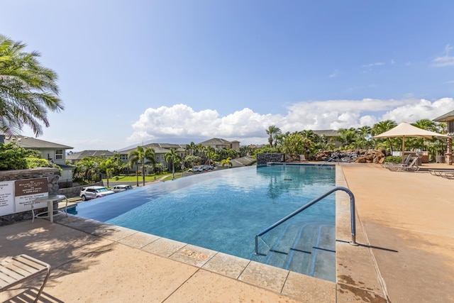 pool with a patio and a residential view