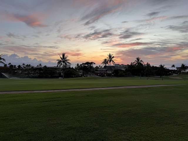 view of home's community with a yard and view of golf course