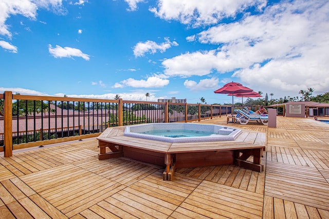 wooden terrace featuring hot tub deck surround
