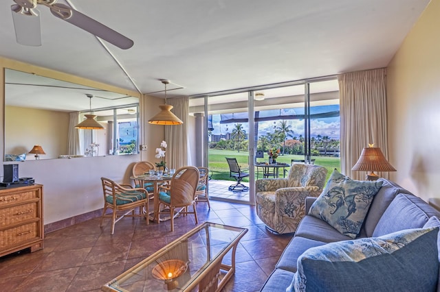 living room with a wall of windows, a healthy amount of sunlight, and a ceiling fan