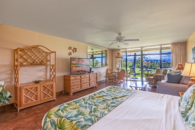 bedroom featuring baseboards, ceiling fan, access to outside, and floor to ceiling windows