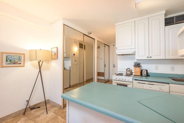 kitchen with white cabinets, washer / dryer, white appliances, and light tile patterned floors