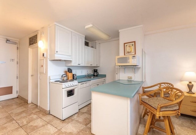 kitchen featuring white cabinets, white appliances, and sink