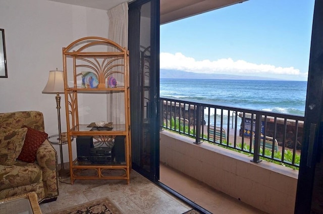 balcony with a water view and a beach view