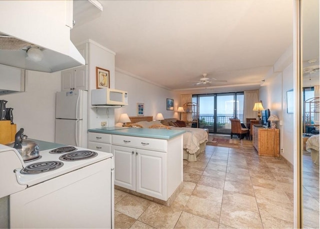 kitchen featuring white appliances, crown molding, ceiling fan, range hood, and white cabinetry