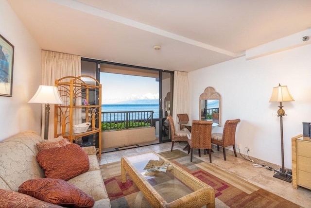 living room featuring a water view and light tile patterned floors