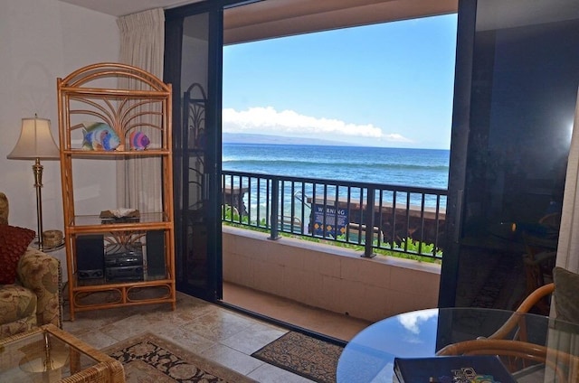 balcony featuring a view of the beach and a water view