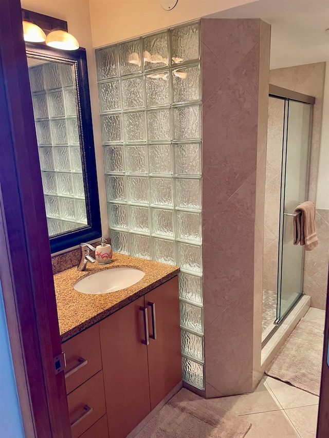 bathroom with tile patterned flooring, an enclosed shower, and vanity