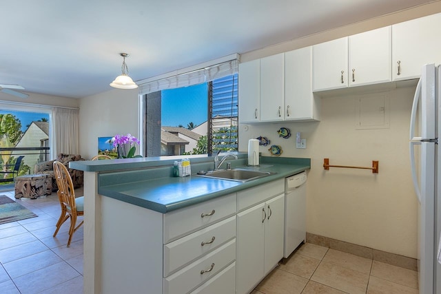 kitchen with white cabinets, sink, white appliances, and a healthy amount of sunlight