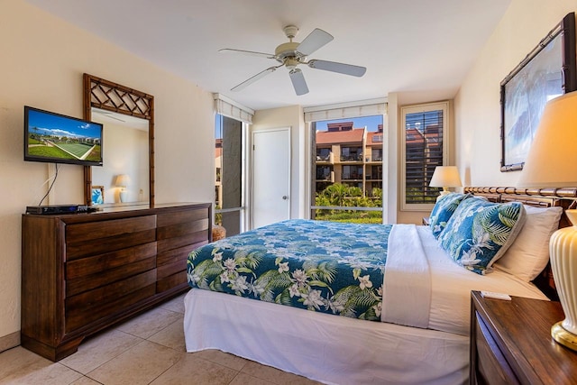 bedroom with ceiling fan and light tile patterned floors