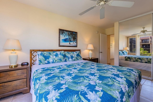 tiled bedroom featuring ceiling fan