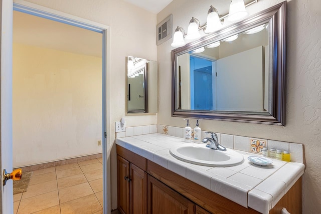 bathroom featuring tile patterned flooring and vanity