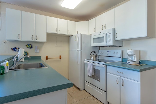 kitchen featuring light tile patterned flooring, sink, white appliances, and white cabinetry