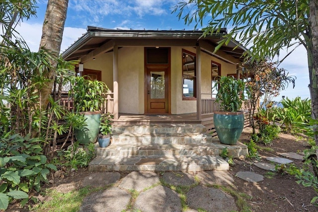 doorway to property featuring a porch