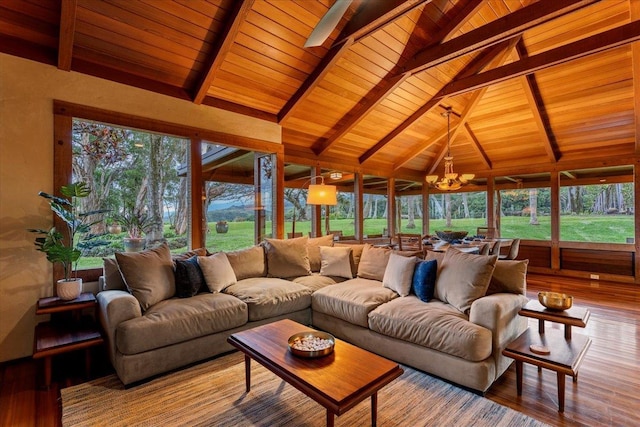 living room featuring hardwood / wood-style flooring, wood ceiling, a chandelier, and lofted ceiling with beams