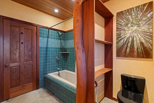 bathroom featuring tiled shower / bath and toilet