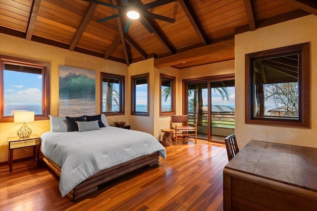 bedroom with hardwood / wood-style flooring, ceiling fan, multiple windows, vaulted ceiling with beams, and wooden ceiling