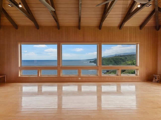 unfurnished sunroom with a water view, a healthy amount of sunlight, wood ceiling, and vaulted ceiling with beams