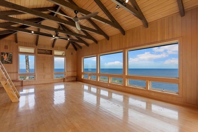 unfurnished sunroom with a water view, lofted ceiling with beams, and wooden ceiling