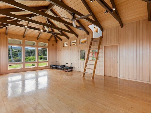 interior space with ceiling fan, wood ceiling, light hardwood / wood-style flooring, and beamed ceiling