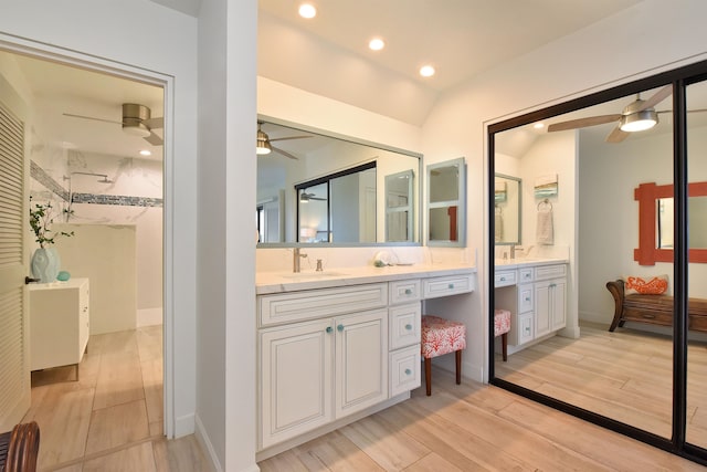 bathroom with wood-type flooring, vanity, walk in shower, and ceiling fan