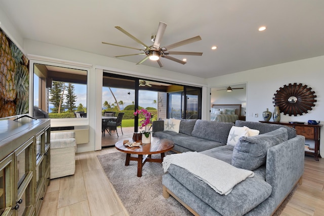 living room featuring ceiling fan and light hardwood / wood-style flooring