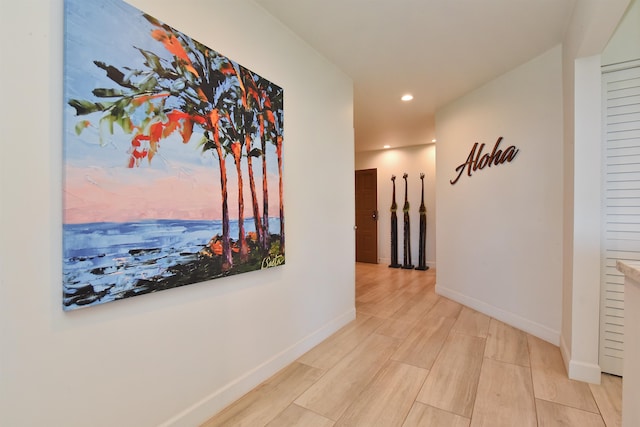 corridor with light hardwood / wood-style flooring