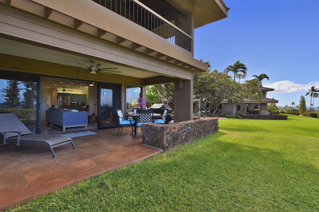 view of yard with ceiling fan and a patio