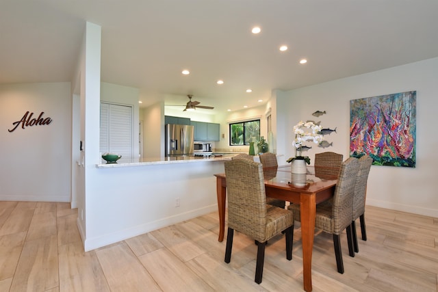 dining room featuring light hardwood / wood-style flooring and ceiling fan