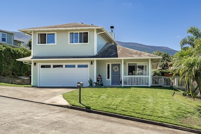 view of front property with a mountain view, a garage, a front yard, and a porch