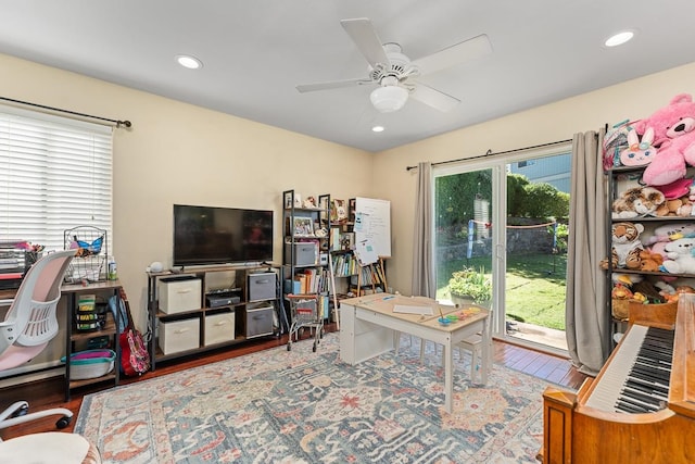 office area with a wealth of natural light, ceiling fan, and hardwood / wood-style floors