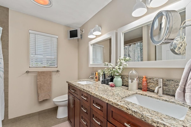 bathroom featuring vanity, toilet, and tile patterned floors