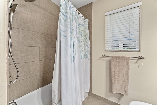 bathroom with toilet and shower / tub combo