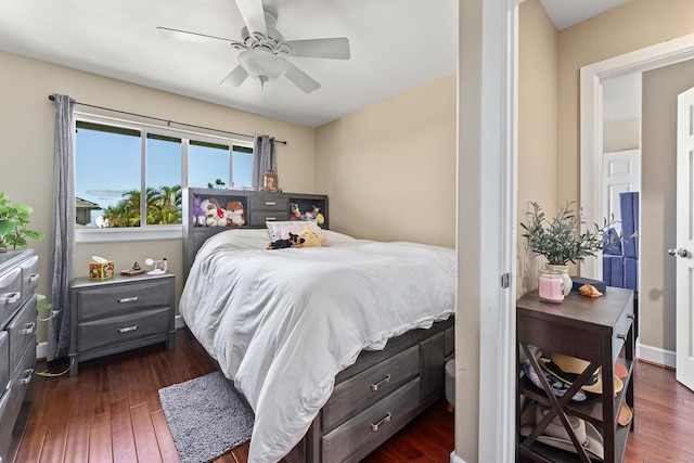 bedroom with dark wood-type flooring and ceiling fan