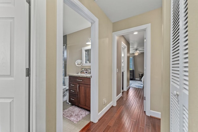 hall with dark hardwood / wood-style floors and sink