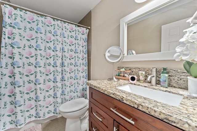 bathroom with vanity, toilet, and walk in shower