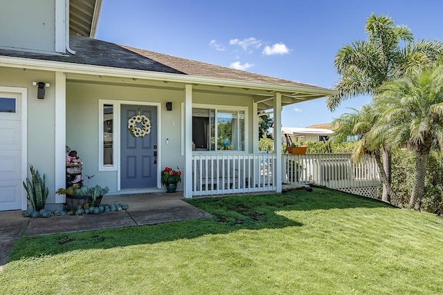 property entrance featuring a yard and covered porch