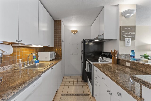 kitchen with backsplash, white cabinetry, sink, white appliances, and light tile patterned flooring