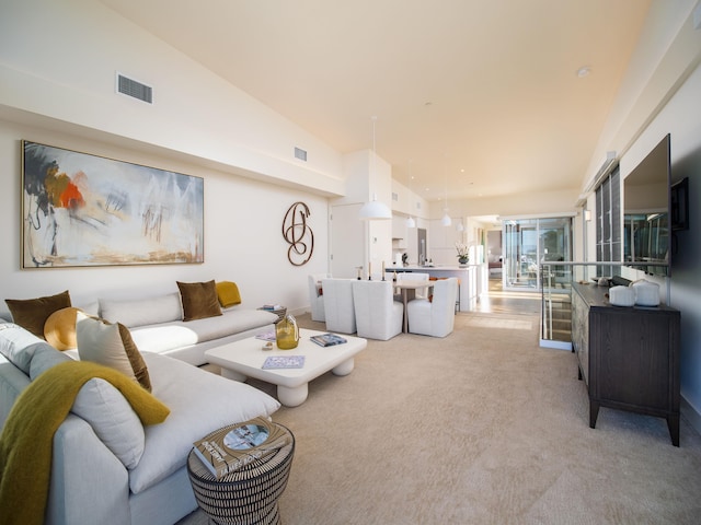 carpeted living room featuring lofted ceiling