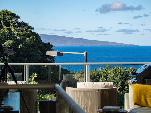 balcony featuring area for grilling and a water and mountain view