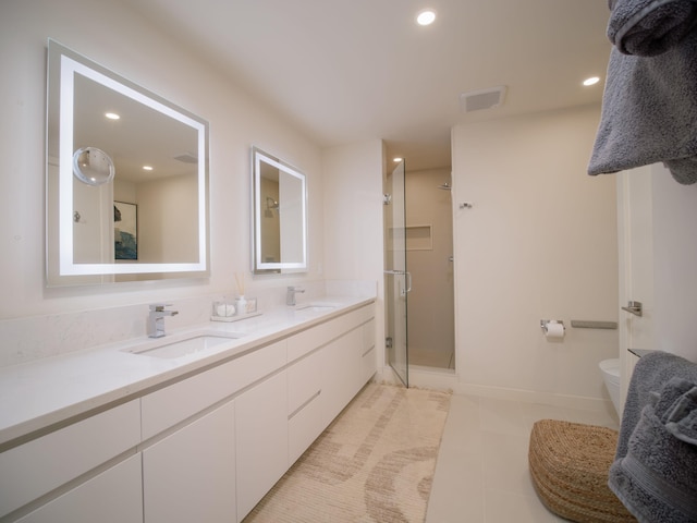 bathroom with tile patterned flooring, vanity, an enclosed shower, and toilet